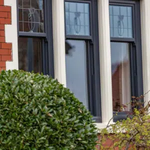 black sash windows with stained glass top