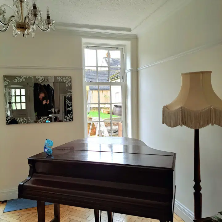 inside of piano room with sash window